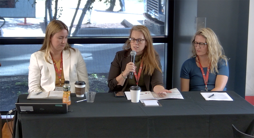 Panelists, three women at a table