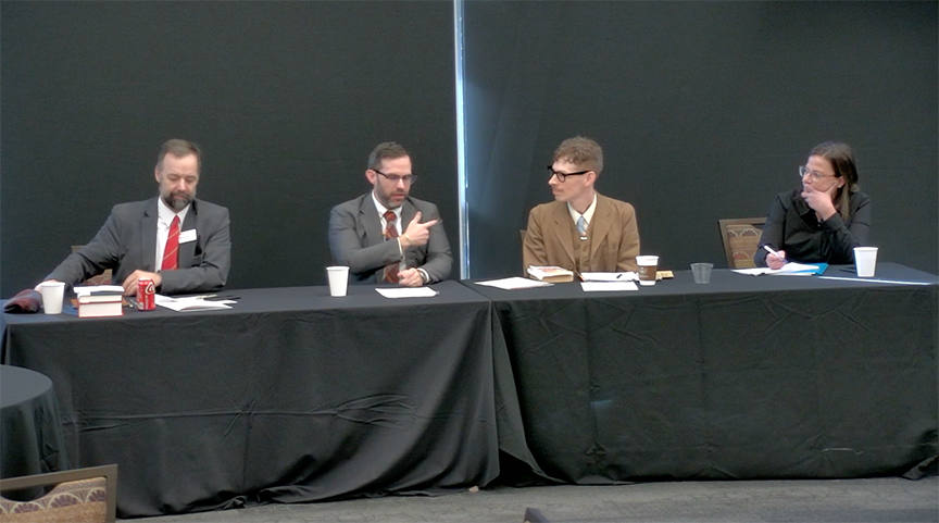 Panelists, four people sitting at a table