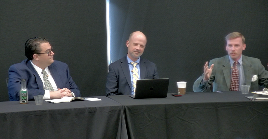 Panelists, three men at a table