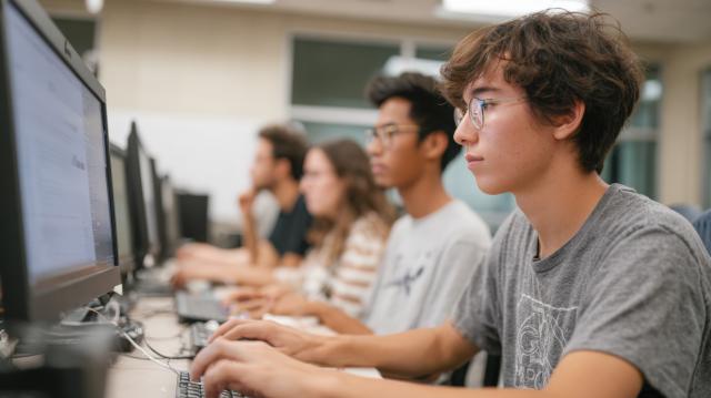 Students writing on computers