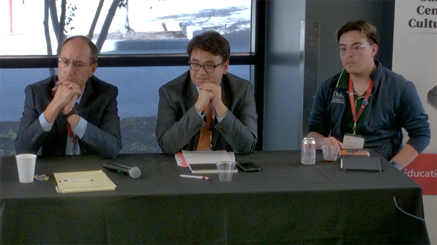 Panelists, 3 men at a table