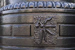 Bottom of a lamp post with a buckeye leaf on Ohio State campus.